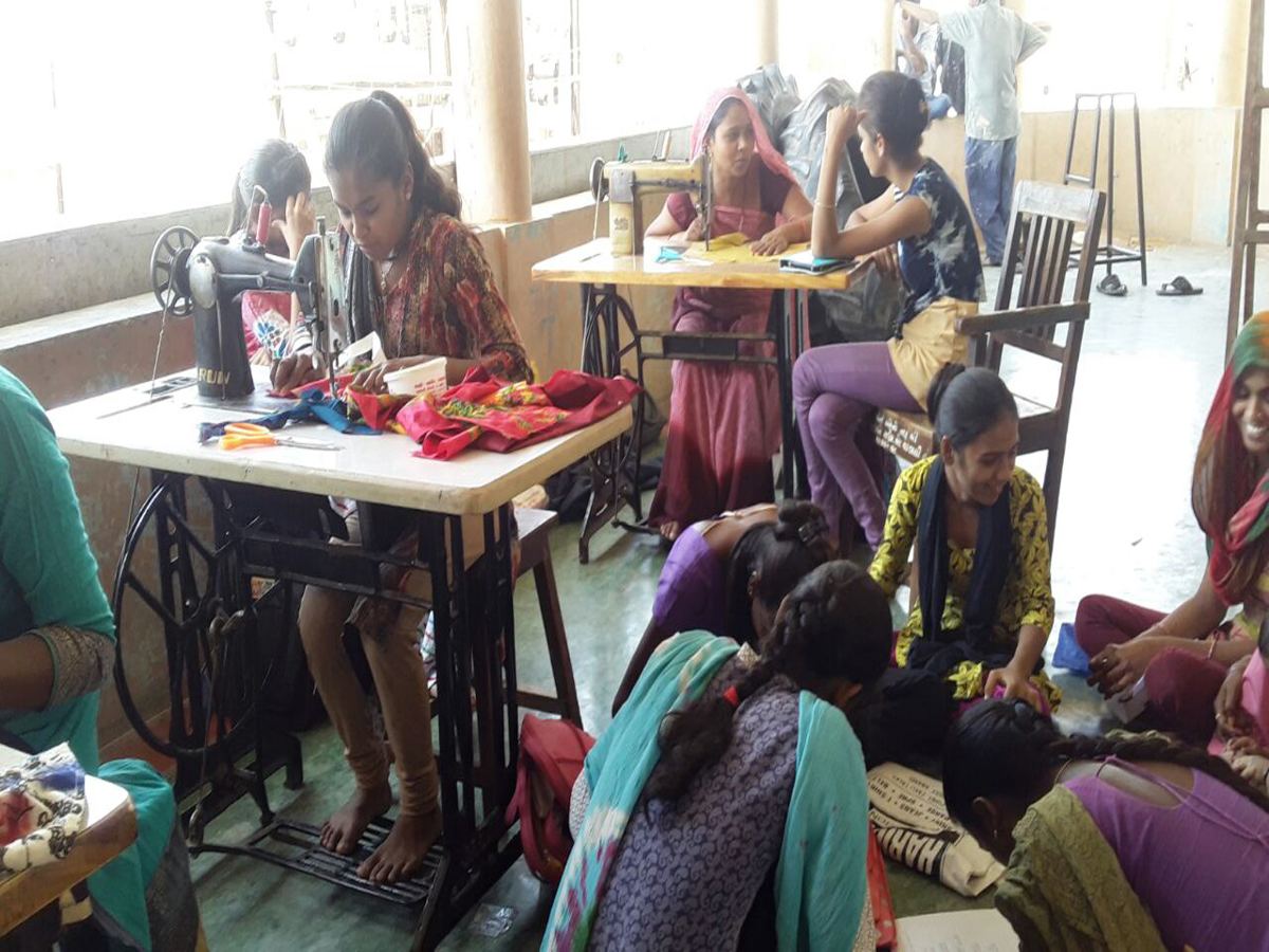 Women learning tailoring on sewing machines